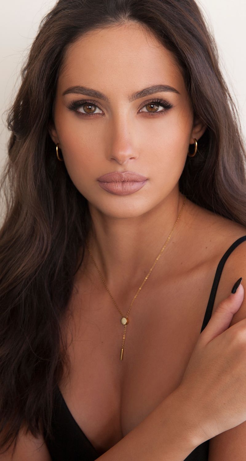 med spa patient model with long hair and gold jewelry.