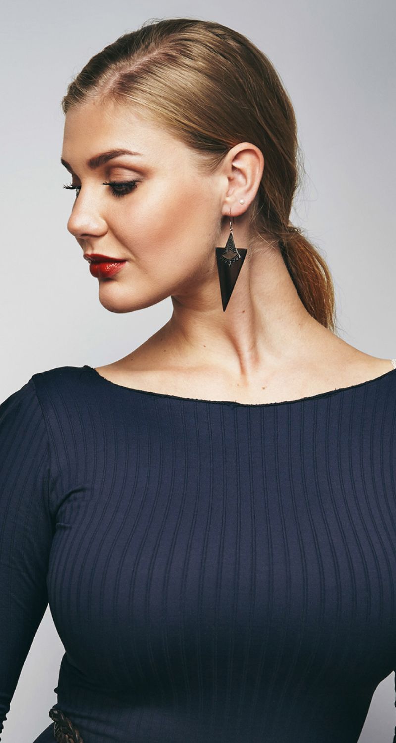 med spa patient model with stylish earrings and a sleek hairstyle.