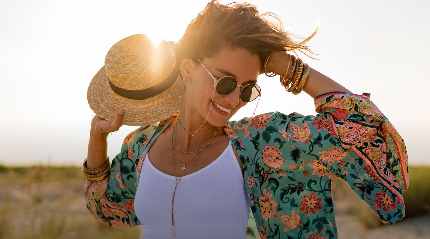 Woman in floral kimono with straw hat.