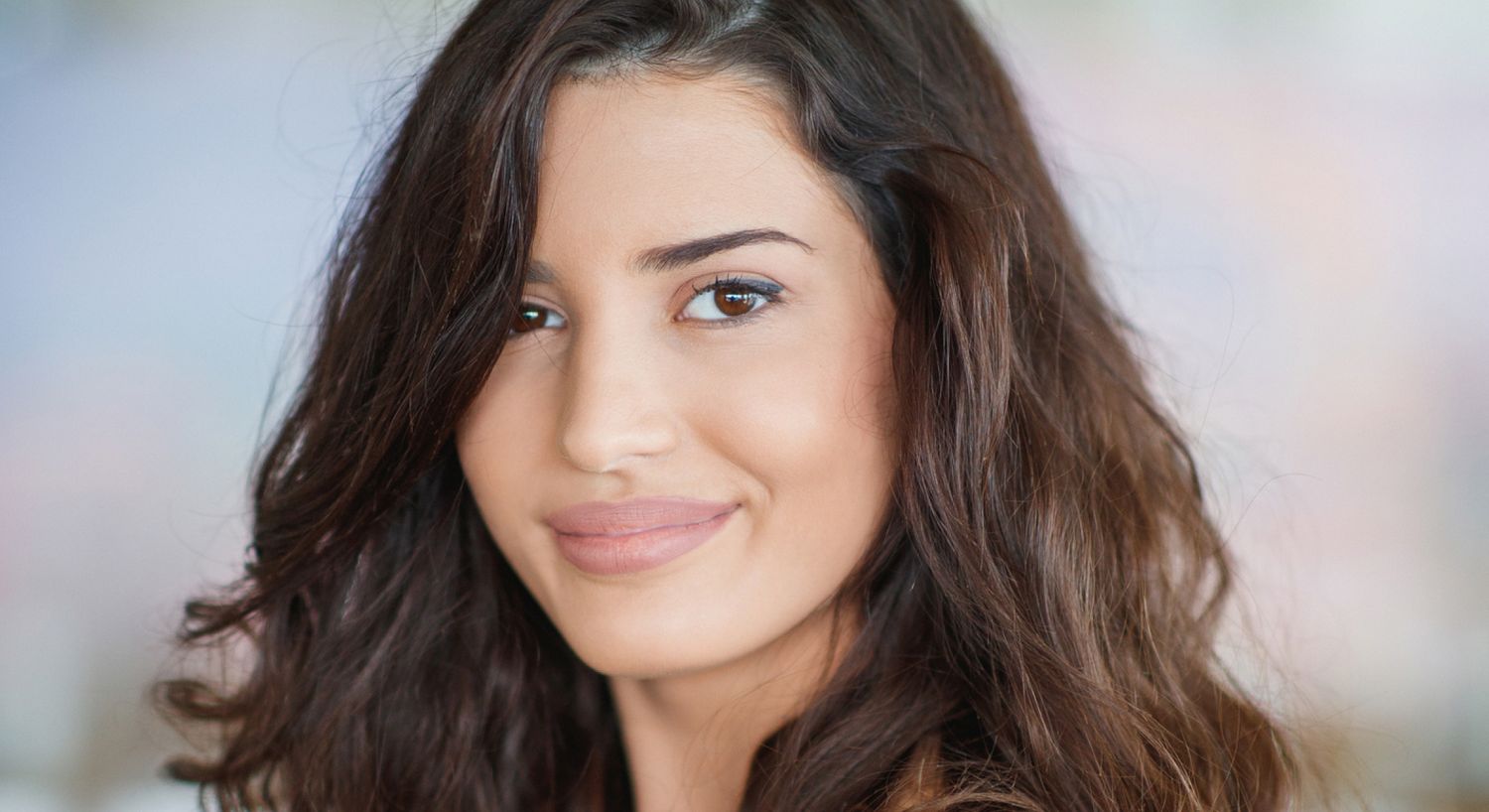 Thread Lift patient model with brown hair smiling