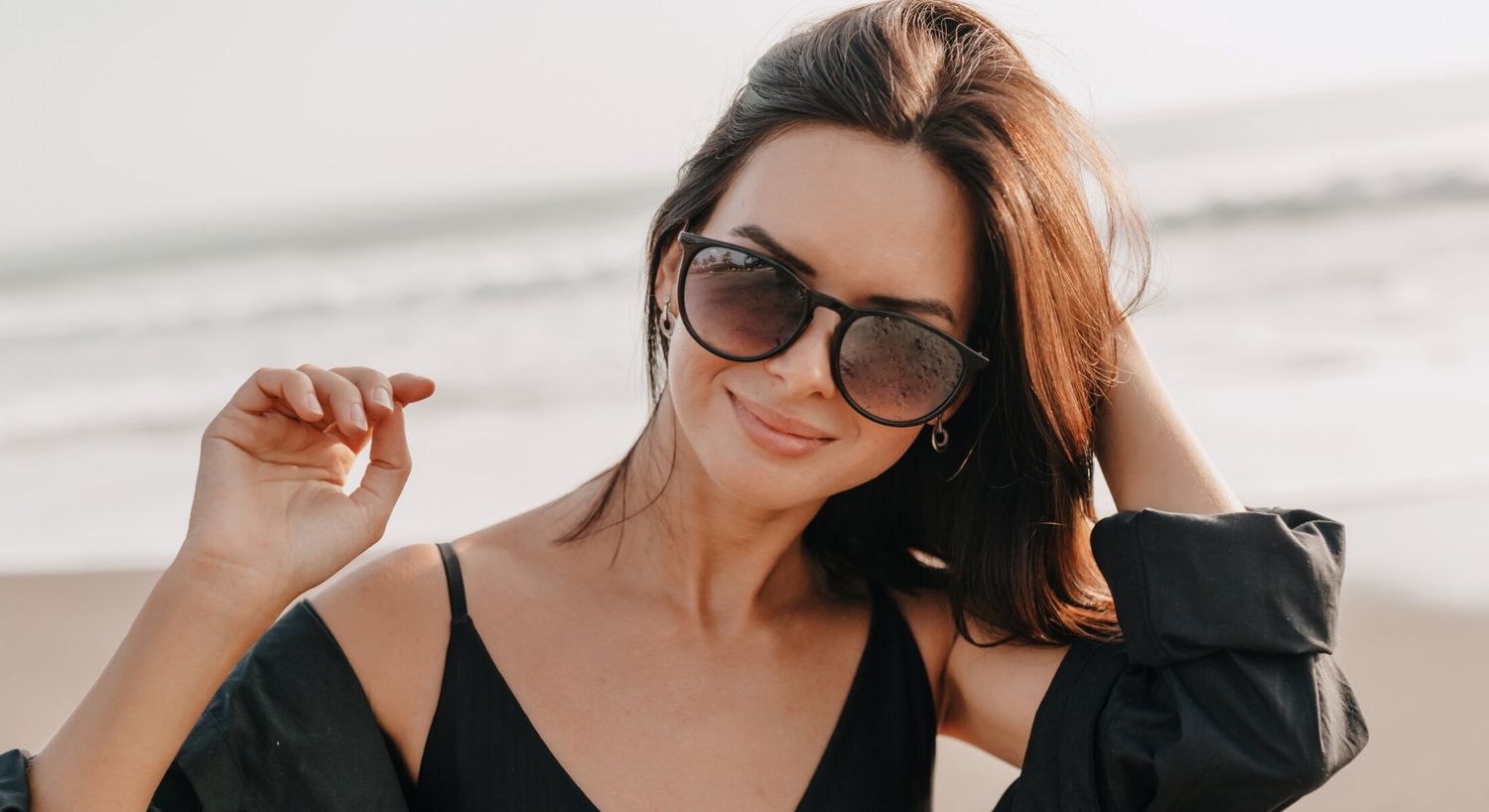 Woman in sunglasses enjoying a beach day.