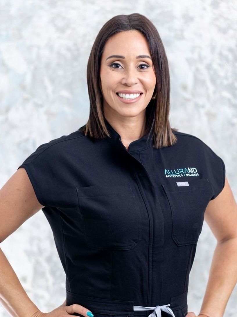 Smiling professional in black medical uniform.